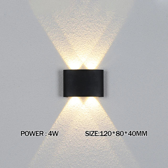 Black wall-mounted light fixture on a gray wall with power and size information displayed.