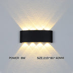 Black wall-mounted light fixture on a textured white wall with power and size information displayed.