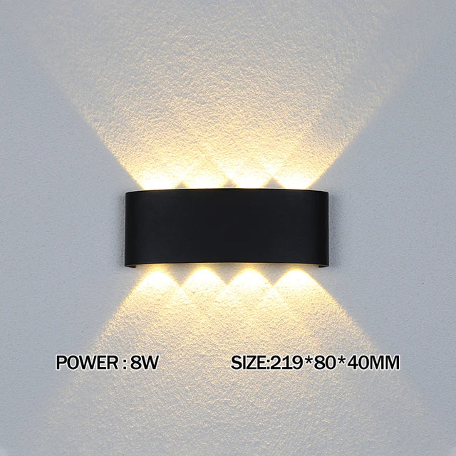 Black wall-mounted light fixture on a textured white wall with power and size information displayed.