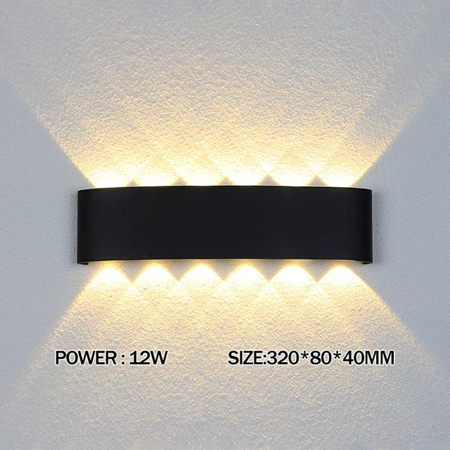Black wall-mounted LED light fixture on a textured wall with power and size information displayed.