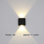 Black wall-mounted light fixture on a gray wall with text indicating power and size.
