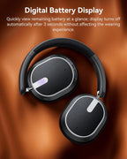 Black headphones with digital battery display on a brown leather background