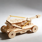 Wooden model of a trebuchet on a gray background