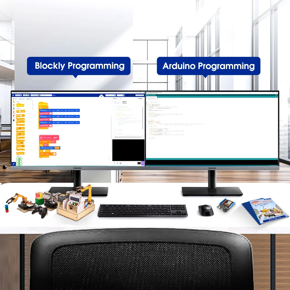 Two computer monitors displaying Blockly Programming and Arduino Programming on a desk with educational materials.