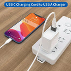Phone charging via USB-C to USB-A cable on a wooden surface