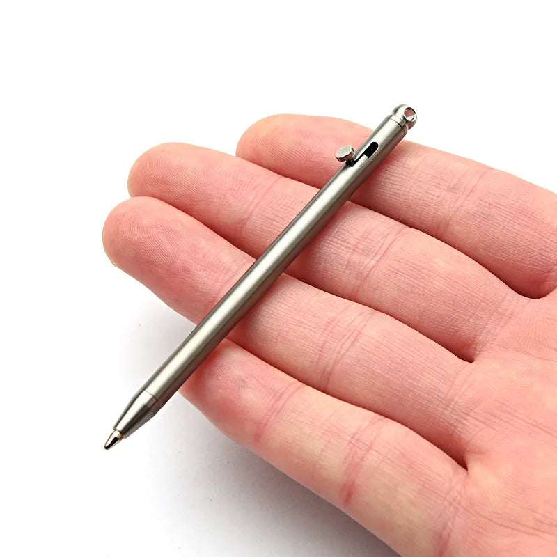 Metallic pen held in a hand on a white background