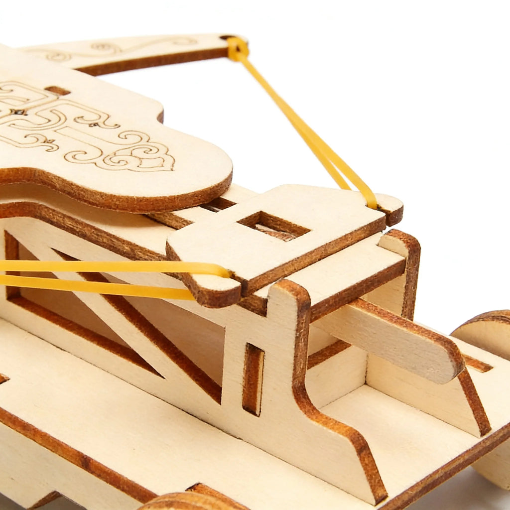 Wooden mechanical model with yellow strings on a white background