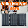 Folding solar panel with '900W' text and person using a laptop in the background