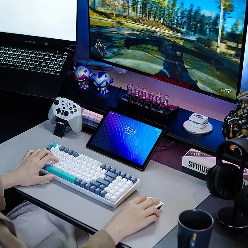 Person playing a game on a computer setup with a keyboard, mouse, and multiple screens.